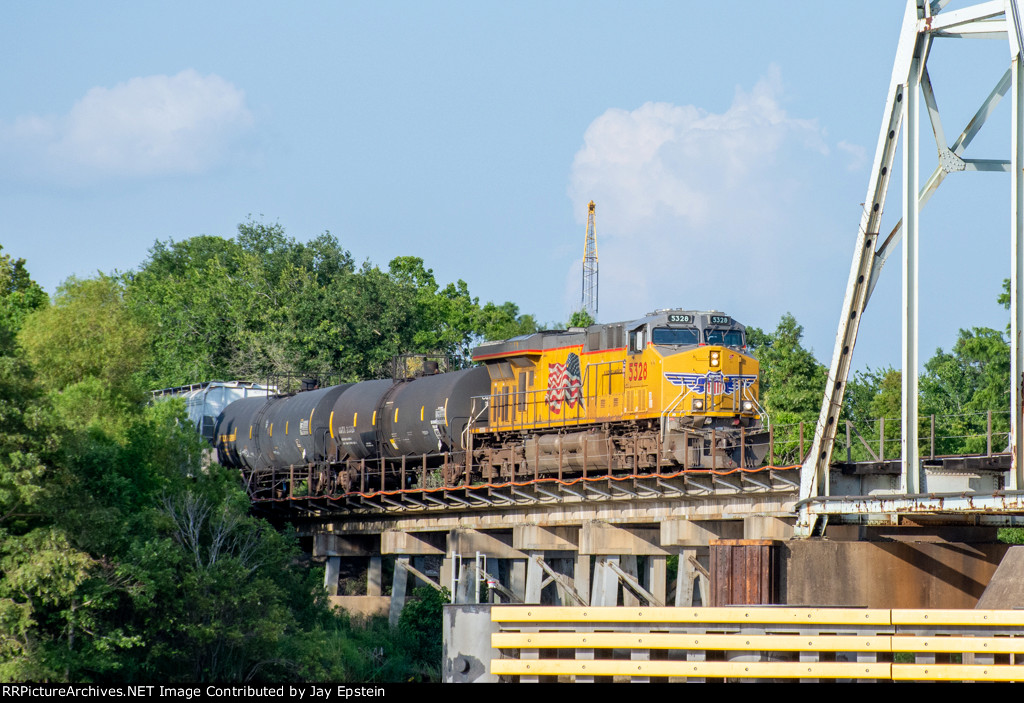 A westbound UP train starts across the Neches River Lift Bridge
